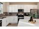 Modern kitchen features white cabinetry, stainless steel appliances, and a stylish backsplash at 1312 Independence St # 3, Lakewood, CO 80215