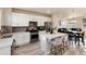 Modern kitchen featuring white cabinetry, stainless steel appliances, and an island with breakfast bar at 1312 Independence St # 3, Lakewood, CO 80215