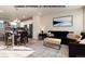 Inviting open-concept living room featuring modern decor and an adjacent kitchen with stainless steel appliances at 1312 Independence St # 3, Lakewood, CO 80215