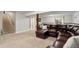 Basement lounge featuring a leather sectional sofa and stairs leading up to the next level at 17540 Caribou Dr, Monument, CO 80132