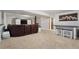 Spacious finished basement featuring plush carpeting, a bar, a leather couch, and a television at 17540 Caribou Dr, Monument, CO 80132