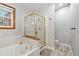 Bright bathroom featuring a separate shower and tub, wood accents, and tile floors at 17540 Caribou Dr, Monument, CO 80132