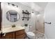 Charming bathroom featuring a wood vanity, stylish lighting, and a glass-enclosed shower at 17540 Caribou Dr, Monument, CO 80132