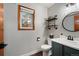 This is a charming bathroom with industrial shelving, a custom vanity, and a beautiful window at 17540 Caribou Dr, Monument, CO 80132