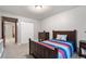 A bright bedroom with wood furnishing, a closet and a dresser against neutral walls at 17540 Caribou Dr, Monument, CO 80132