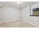 An empty bedroom with a window, neutral colored walls and carpet at 17540 Caribou Dr, Monument, CO 80132