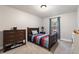 Cozy bedroom with a comfortable bed, dresser, bedside table, and a bright window at 17540 Caribou Dr, Monument, CO 80132