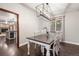 Bright dining room with hardwood floors, a stylish light fixture, and views of the outside at 17540 Caribou Dr, Monument, CO 80132