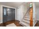 Foyer with hardwood floors, a stylish front door, and a carpeted staircase leading to the upper level at 17540 Caribou Dr, Monument, CO 80132