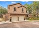 Two-story home featuring a two-car garage with stone accents and manicured landscaping at 17540 Caribou Dr, Monument, CO 80132