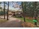 Charming home nestled among mature trees, featuring a stone-accented exterior and a long private drive at 17540 Caribou Dr, Monument, CO 80132