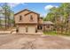 Inviting two-story home featuring a two-car garage, stone accents, and a well-manicured front yard at 17540 Caribou Dr, Monument, CO 80132