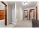 Bright hallway with carpet, showing access to the bedrooms and the rest of the home at 17540 Caribou Dr, Monument, CO 80132