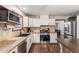 Bright kitchen featuring modern appliances, granite countertops, and ample cabinet space at 17540 Caribou Dr, Monument, CO 80132