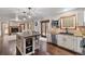 Open-concept kitchen flows into the living area with stainless steel appliances and a stylish island at 17540 Caribou Dr, Monument, CO 80132