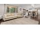 Inviting living room with large windows, a comfortable sofa, and seamless access to the kitchen at 17540 Caribou Dr, Monument, CO 80132