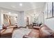 Open-concept living room featuring hardwood floors, comfortable sofas, and a dining area at 17540 Caribou Dr, Monument, CO 80132