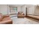 Comfortable living room with hardwood floors, a large window seat, and a cozy leather chair at 17540 Caribou Dr, Monument, CO 80132