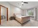 Bright main bedroom featuring neutral carpet, stylish bed, and a cozy window nook at 17540 Caribou Dr, Monument, CO 80132