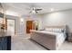 Spacious main bedroom boasts a plush king bed, soft carpet, and ample natural light at 17540 Caribou Dr, Monument, CO 80132