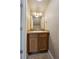 Small bathroom with wood vanity and mirror at 906 S Peoria St, Aurora, CO 80012