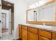 Bathroom boasts double sinks, wood cabinets, and a large mirror at 906 S Peoria St, Aurora, CO 80012