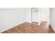 Bright bedroom with wood-look floors and mirrored closet doors at 906 S Peoria St, Aurora, CO 80012