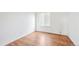 Spacious bedroom featuring wood-look floors and a window with blinds at 906 S Peoria St, Aurora, CO 80012