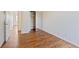 Well-lit bedroom with wood-look floors and mirrored closet at 906 S Peoria St, Aurora, CO 80012
