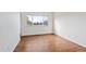 Bedroom with large window, wood-look floors, and ample wall space at 906 S Peoria St, Aurora, CO 80012