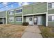 Green townhome exterior with landscaping and walkway at 906 S Peoria St, Aurora, CO 80012