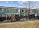 Green townhouses with wooden fences and a shared yard at 906 S Peoria St, Aurora, CO 80012
