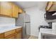 Galley kitchen with wood cabinets and appliances at 906 S Peoria St, Aurora, CO 80012