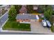 Aerial view of brick home featuring a well-maintained lawn and a long driveway for parking at 5320 W 62Nd Ave, Arvada, CO 80003