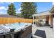 Relax in this backyard with a hot tub, a covered patio, and mature trees at 5320 W 62Nd Ave, Arvada, CO 80003