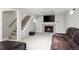 Finished basement with comfortable seating, fireplace and modern staircase at 5320 W 62Nd Ave, Arvada, CO 80003