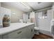 Bright bathroom with marble counters, updated cabinets, tub, and shower at 5320 W 62Nd Ave, Arvada, CO 80003