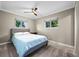 Comfortable bedroom featuring a ceiling fan, two windows, and neutral paint at 5320 W 62Nd Ave, Arvada, CO 80003
