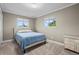 Cozy bedroom featuring neutral tones, two windows, and a comfortable bed at 5320 W 62Nd Ave, Arvada, CO 80003