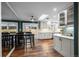 Bright kitchen with skylight, modern appliances, and dining area with backyard access at 5320 W 62Nd Ave, Arvada, CO 80003
