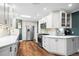 Contemporary kitchen featuring stainless steel appliances, white cabinets, and stylish backsplash at 5320 W 62Nd Ave, Arvada, CO 80003