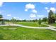 Park view features walking path, a grassy field, trees, and an open-air picnic structure at 5320 W 62Nd Ave, Arvada, CO 80003
