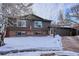 Brick and wood ranch home with snowy front yard at 4973 S Taft St, Morrison, CO 80465