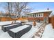 Snowy backyard with patio, garden boxes, and shed at 2410 S Lincoln St, Denver, CO 80210