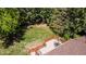 Aerial view of a well-maintained backyard featuring a wooden deck, mature trees, and a lush lawn at 879 S Cole Dr, Lakewood, CO 80228