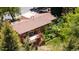 Aerial view of a beautiful home featuring a spacious deck, lush landscaping, mature trees and a private backyard at 879 S Cole Dr, Lakewood, CO 80228