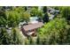 Aerial view of a single-Gathering home nestled among lush trees with a private backyard and wooden deck at 879 S Cole Dr, Lakewood, CO 80228