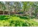 Serene backyard with a swing set, mature trees, and a storage shed, creating a peaceful outdoor retreat at 879 S Cole Dr, Lakewood, CO 80228