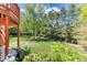 Expansive backyard with mature trees and a lush lawn off the back patio at 879 S Cole Dr, Lakewood, CO 80228
