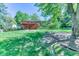 Well-maintained backyard featuring a deck, brick exterior and mature trees at 879 S Cole Dr, Lakewood, CO 80228